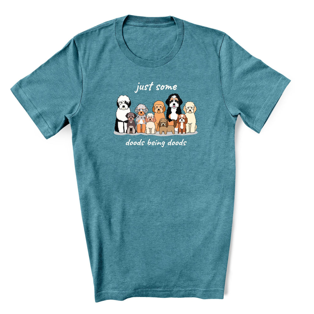 Cute teal shirt for doodle lover - it has a group of different size and types of doodle dogs sitting with text "Just some Doods being Doods"