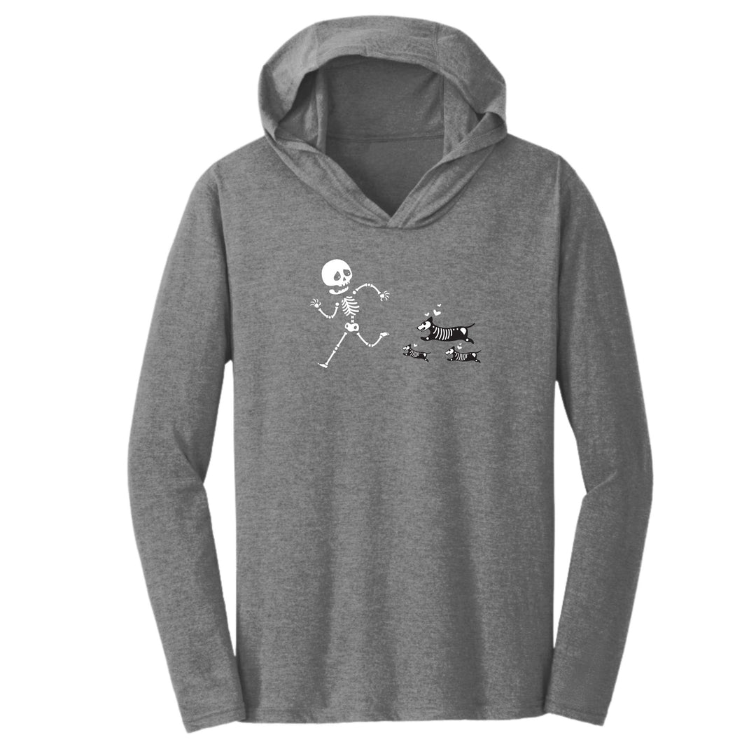 A Unisex hoodie with a skeleton being chased by a cute pack of dogs - funny halloween hoodie